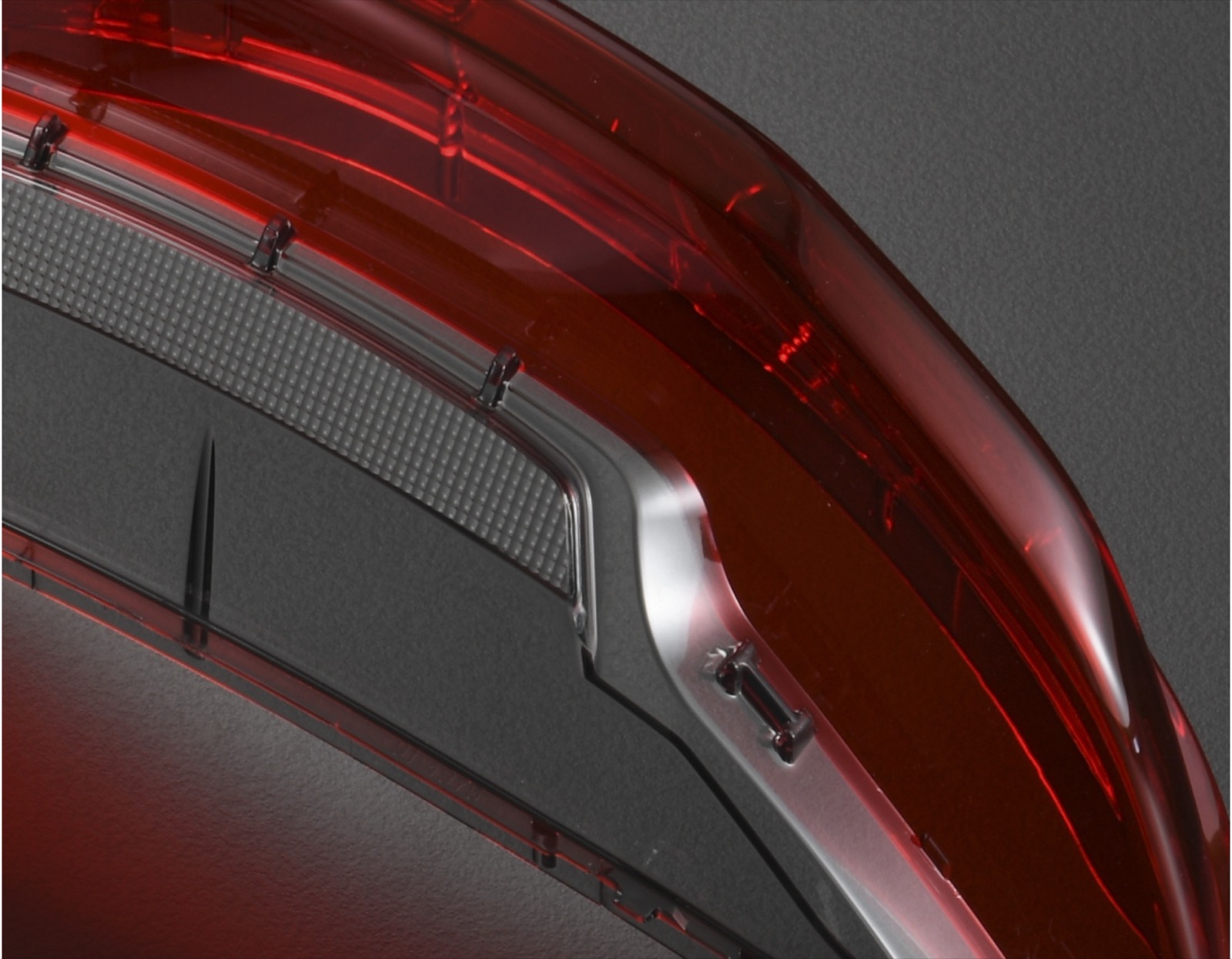 Two-shot (2K) automotive tail-light lens with chrome trim